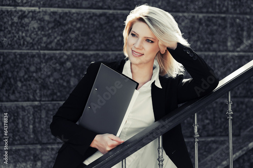 Photo: Young business woman with a folder Young business woman with a folder