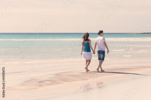 Photo: Young Couple Walking on Caribbean Beach Young Couple Walking on Caribbean Beach