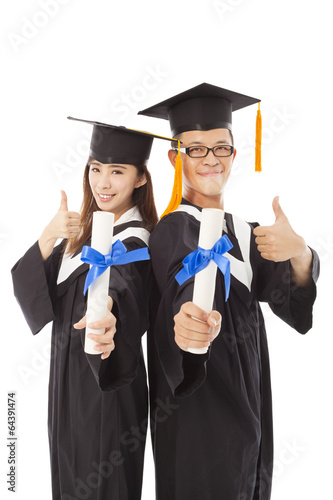 Photo: happy graduating students with thumb up happy graduating students with thumb up