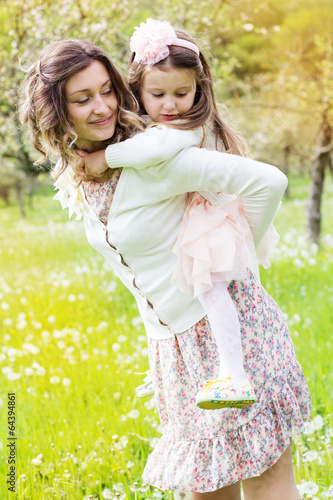 Photo: Mother and daughter in field with dandelions Mother and daughter in field with dandelions