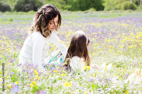 Photo: Mother and daughter in field with colorful flowers Mother and daughter in field with colorful flowers