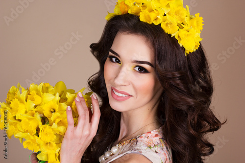 Photo: Happy smiling girl with yellow flowers Happy smiling girl with yellow flowers