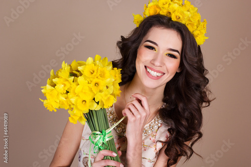Photo: Happy smiling girl with yellow flowers Happy smiling girl with yellow flowers