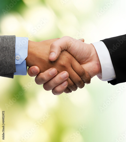 Photo: businessman and businesswoman shaking hands businessman and businesswoman shaking hands