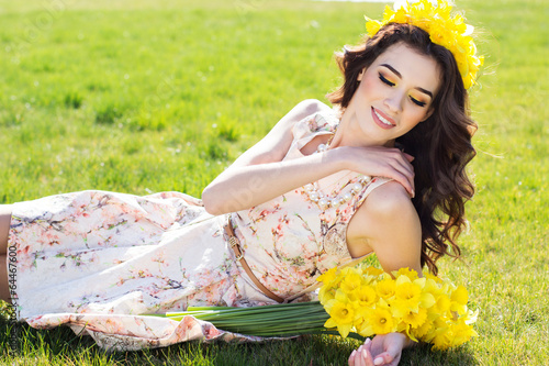 Photo: Happy smiling girl with yellow flowers Happy smiling girl with yellow flowers
