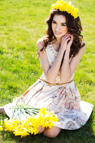 Photo: Happy smiling girl with yellow flowers Happy smiling girl with yellow flowers