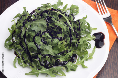 Photo: Rocket salad with balsamic vinegar on white plate Rocket salad with balsamic vinegar on white plate