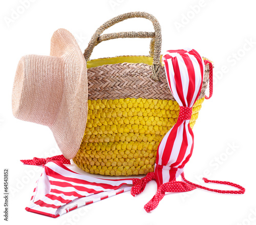 Photo: Wicker bag and swimsuit, isolated on white Wicker bag and swimsuit, isolated on white
