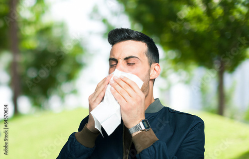 Photo: Man blowing his nose Man blowing his nose