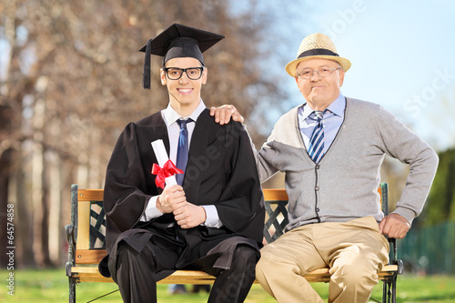 Photo: Proud son and father posing in park Proud son and father posing in park