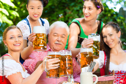 Photo: Im Biergarten - Freunde trinken Bier in Bayern Im Biergarten - Freunde trinken Bier in Bayern