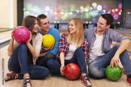 Photo: Young group of friends have fun at bowling alley Young group of friends have fun at bowling alley