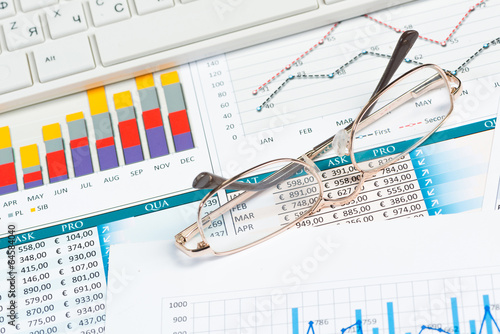 Photo: close-up glasses with business papers close-up glasses with business papers