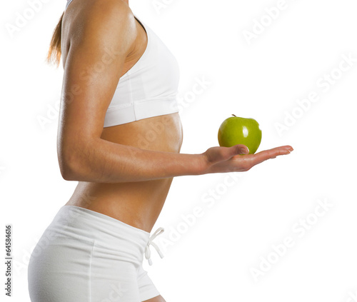 Photo: young attractive sporty woman with green apple young attractive sporty woman with green apple