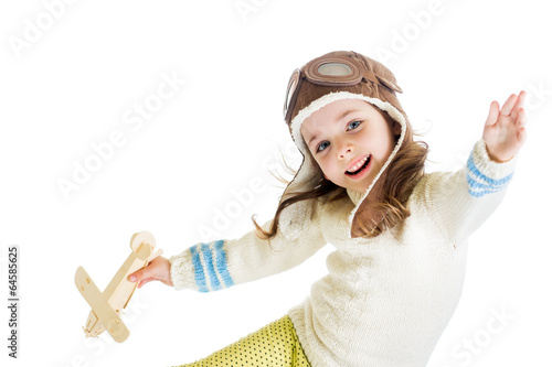 Photo: funny kid dressed as pilot and playing with wooden airplane toy funny kid dressed as pilot and playing with wooden airplane toy