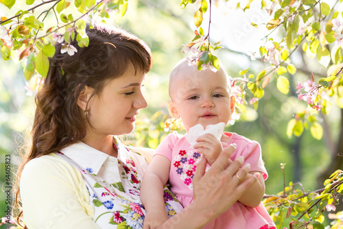 Photo: Allergy. Mother and baby blowing nose outdoors Allergy. Mother and baby blowing nose outdoors