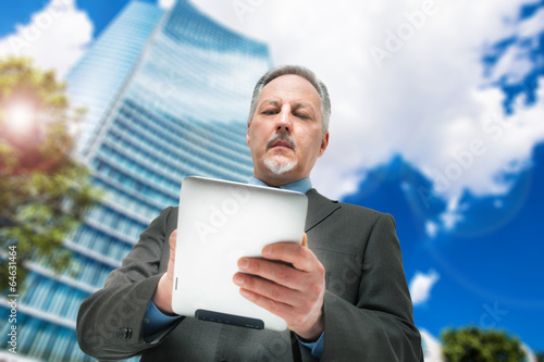 Photo: Business man using a touchpad Business man using a touchpad