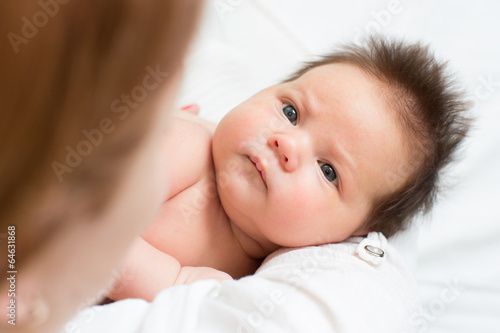 Photo: newborn baby looking at mom newborn baby looking at mom