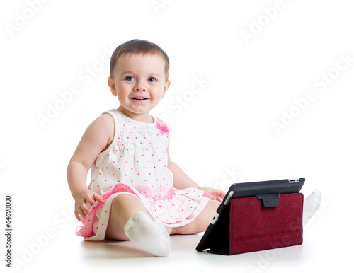 Photo: baby girl playing with a digital tablet baby girl playing with a digital tablet