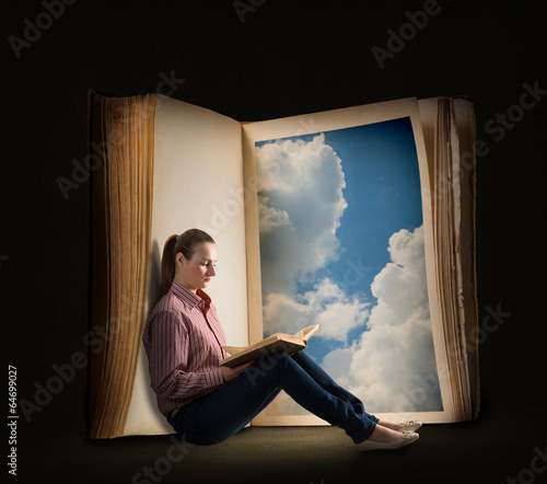 Photo: young woman reading a book young woman reading a book