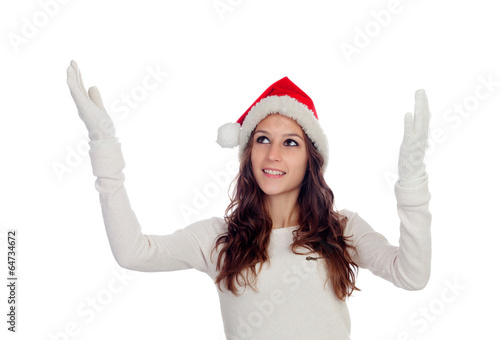 Photo: Attractive casual girl with Christmas hat extending her arms Attractive casual girl with Christmas hat extending her arms