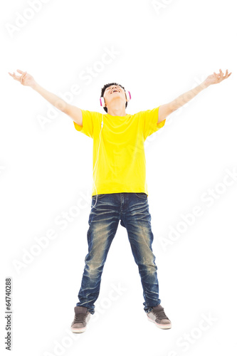 Photo: young man standing and listening music young man standing and listening music