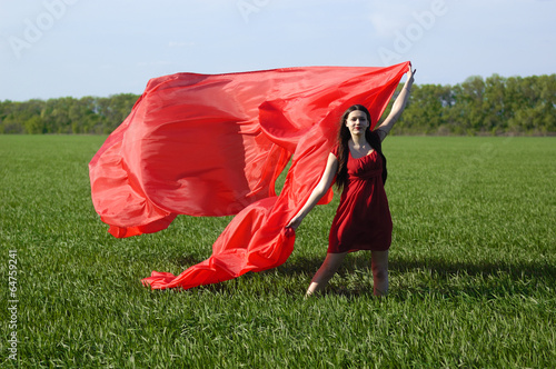 Photo: young lady in red dress on field young lady in red dress on field