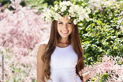 Photo: Beautiful girl on the nature in wreath of flowers Beautiful girl on the nature in wreath of flowers