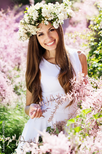 Photo: Beautiful girl on the nature in wreath of flowers Beautiful girl on the nature in wreath of flowers