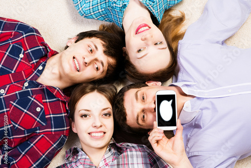 Photo: four young men lie together four young men lie together