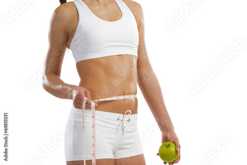 Photo: young athletic woman holding a green apple young athletic woman holding a green apple