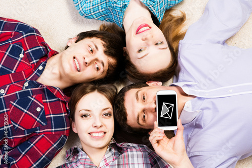 Photo: four young men lie together four young men lie together