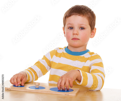 Photo: little boy playing at the table little boy playing at the table