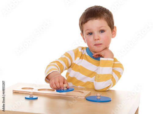 Photo: little boy playing at the table little boy playing at the table