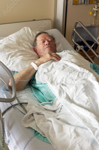 Senior in hospital bed vertical - 64860214