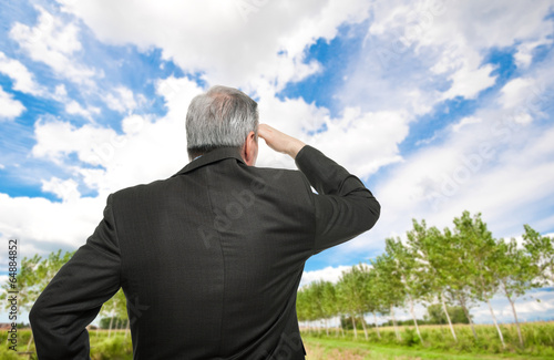 Photo: Business man looking at the horizon Business man looking at the horizon
