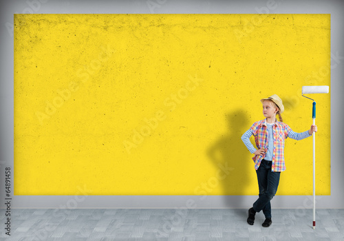 Photo: girl in a hat with a roller for painting girl in a hat with a roller for painting