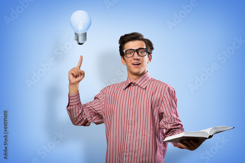 Photo: young man holding a book young man holding a book