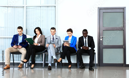 Photo: Business people waiting for job interview Business people waiting for job interview