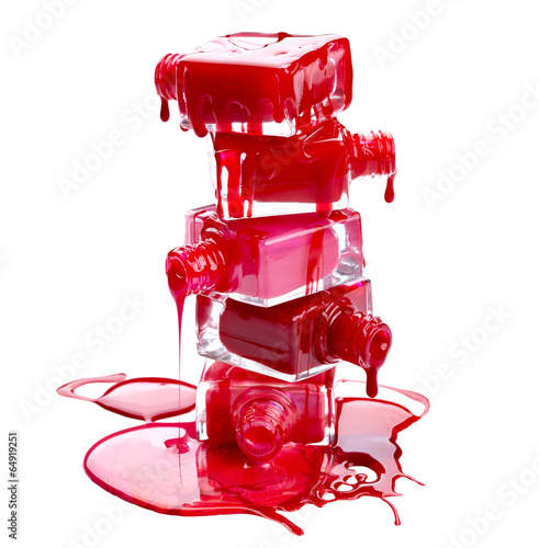 Photo: Bottles with spilled nail polish isolated on white background Bottles with spilled nail polish isolated on white background