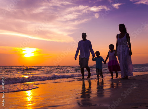 Photo: Family walking on the beach Family walking on the beach