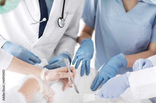 Photo: young group of doctors doing operation young group of doctors doing operation