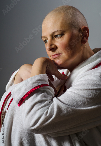 Photo: Bald woman suffering from cancer sitting in the chair Bald woman suffering from cancer sitting in the chair