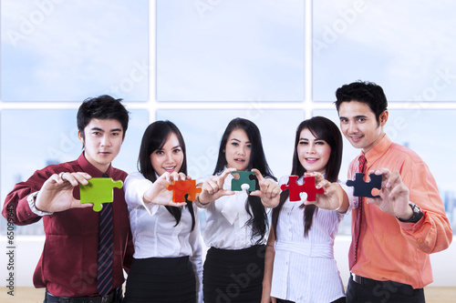 Photo: Business teamwork and puzzle pieces Business teamwork and puzzle pieces
