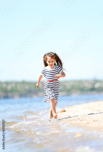 Photo: Beautiful little girl on the beach Beautiful little girl on the beach