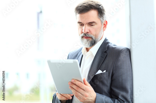 Photo: Businessman using a tablet computer Businessman using a tablet computer