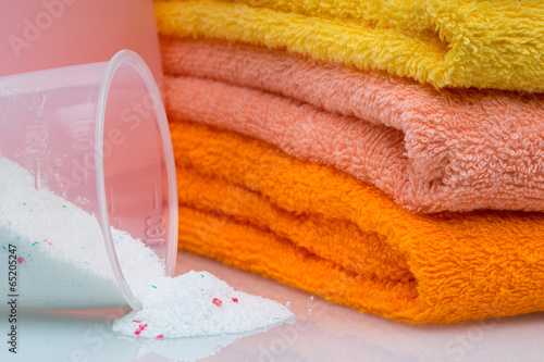 Photo: Detergent for washing machine in laundry with towels Detergent for washing machine in laundry with towels