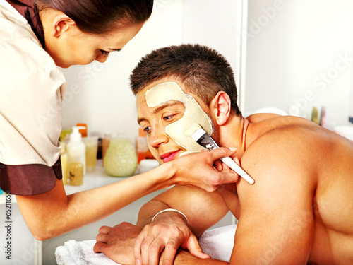 Photo: Clay facial mask in beauty spa. Clay facial mask in beauty spa.