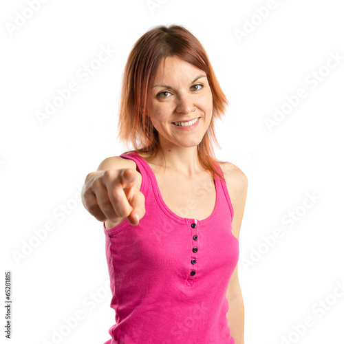 Photo: Young girl pointing over white background Young girl pointing over white background