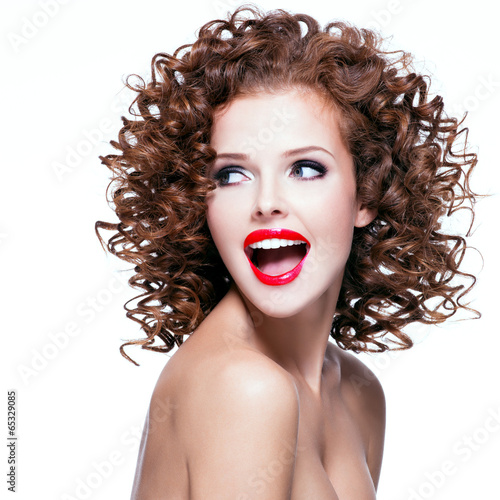 Photo: Beautiful laughing woman with brunette curly hair. Beautiful laughing woman with brunette curly hair.